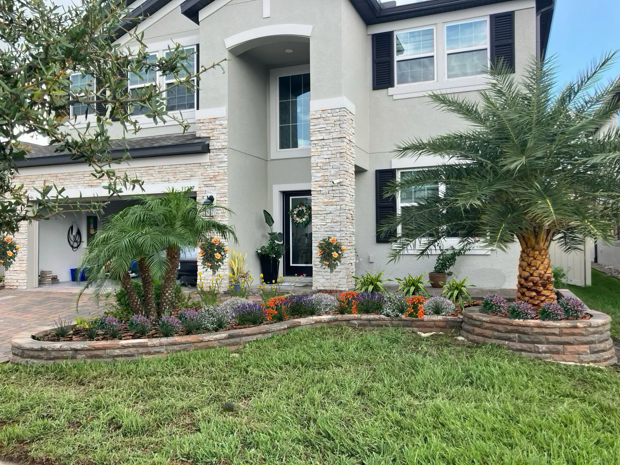 Curved stone planting beds with lavender, ornamental grasses, palms, and seasonal flowers in front yard